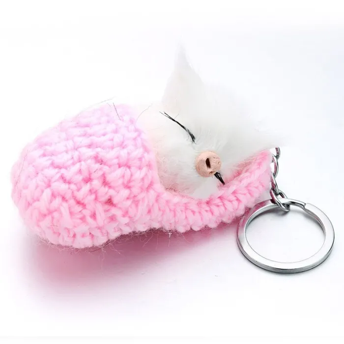 Sleeping cat in a hand-woven cot - keychainKeyrings