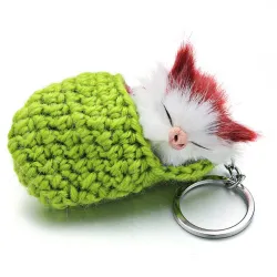 Sleeping cat in a hand-woven cot - keychainKeyrings