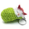 Sleeping cat in a hand-woven cot - keychainKeyrings